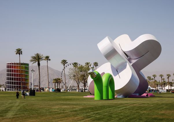 Wide shot of “Holoflux” installation with Ferris wheel and other structures in background