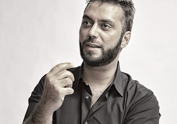 Güvenç Özel in black shirt