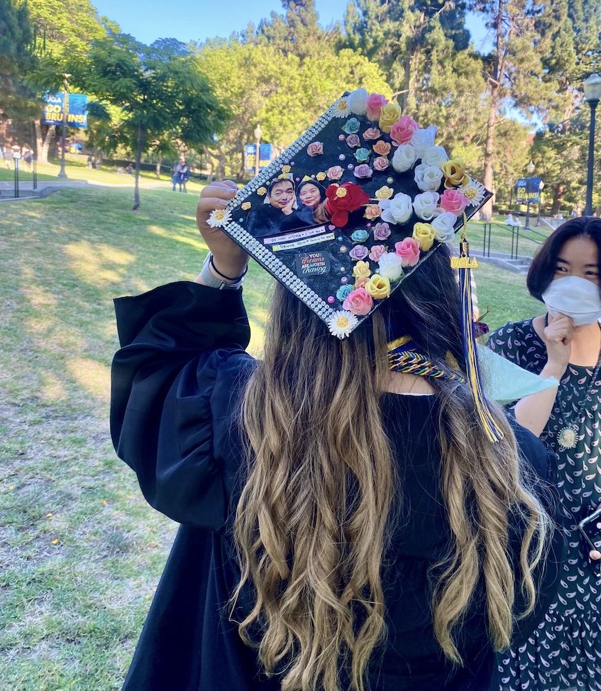 Gloria Jiyoon Kim standing with back to the camera and displaying her decorated graduation mortarboard
