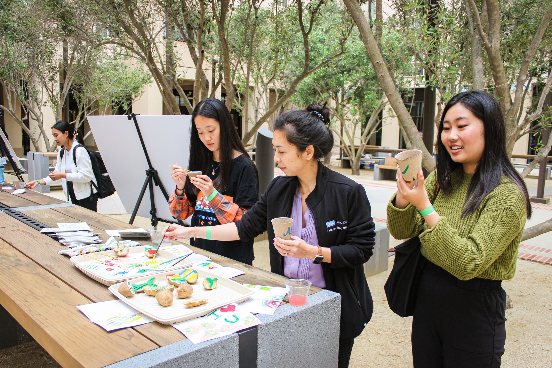 People painting on potatoes and other items 