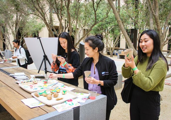 People painting on potatoes and other items 