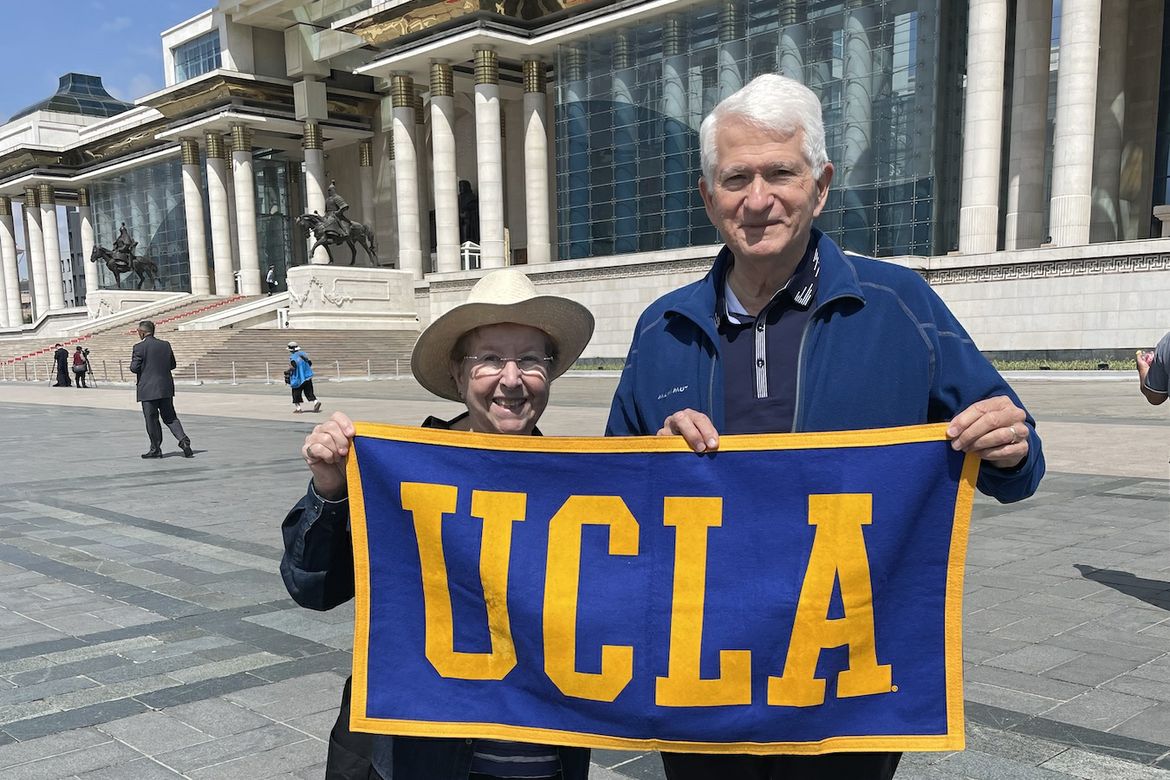 Carol and Gene Block hold up UCLA banner