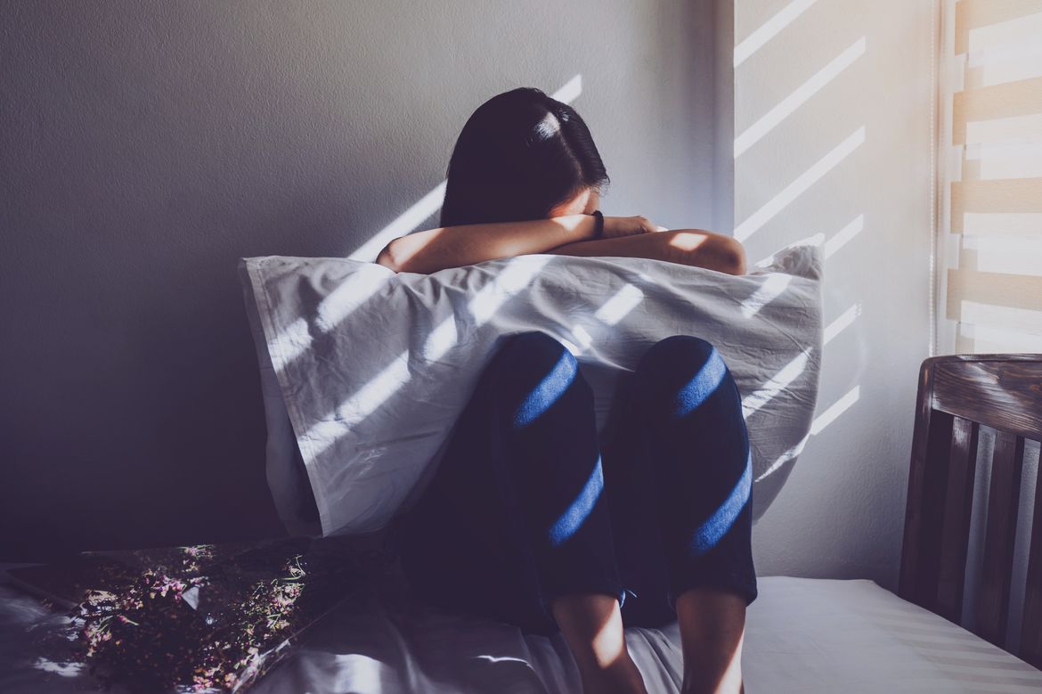 Adolescent with head on pillow 