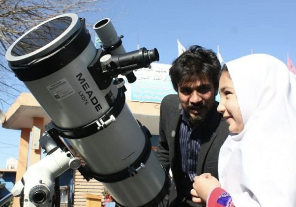 Abraham Amiri with young girl and a telescope