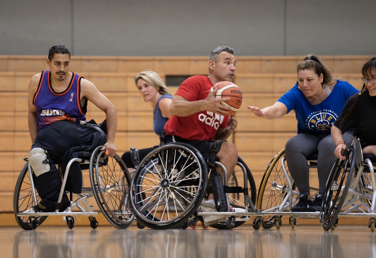Action shot of five players participating in UCLA Open Rec wheelchair basketball