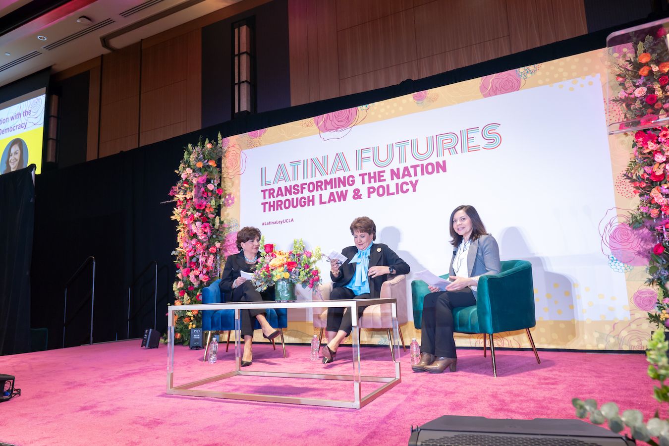 Mary Murguía, Janet Murguía and Margaret Salazar-Porzio on stage
