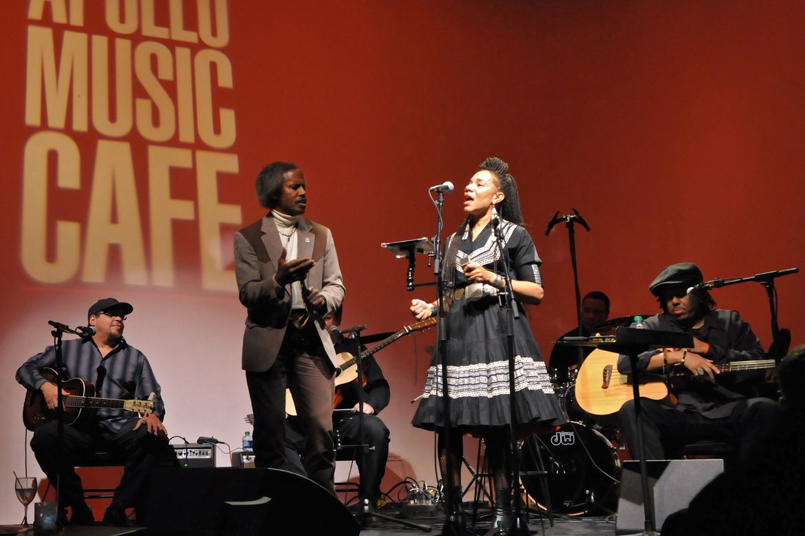 Martha Redbone singing on stage in a black dress