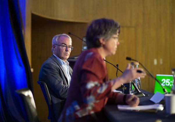 William Boyd, left, watching a speaker to his right