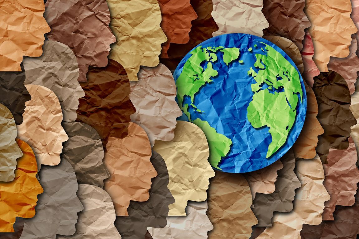 Photo of a paper collage of various faces in profile and the Earth