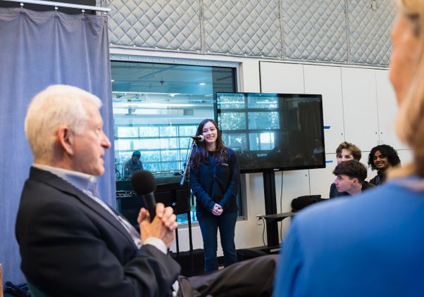 Student standing at microphone to ask a question