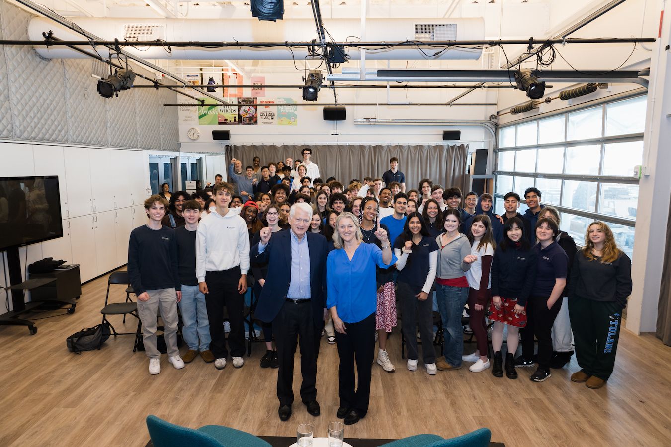 Chancellor and Sibyll Carnochan Catalan make No. 1 hand gestures in air with students in background
