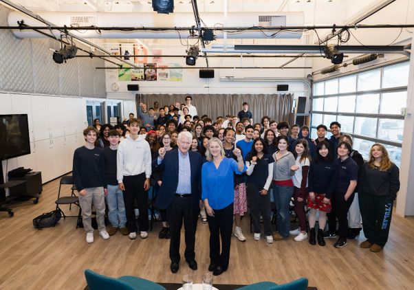 Chancellor and Sibyll Carnochan Catalan make No. 1 hand gestures in air with students in background