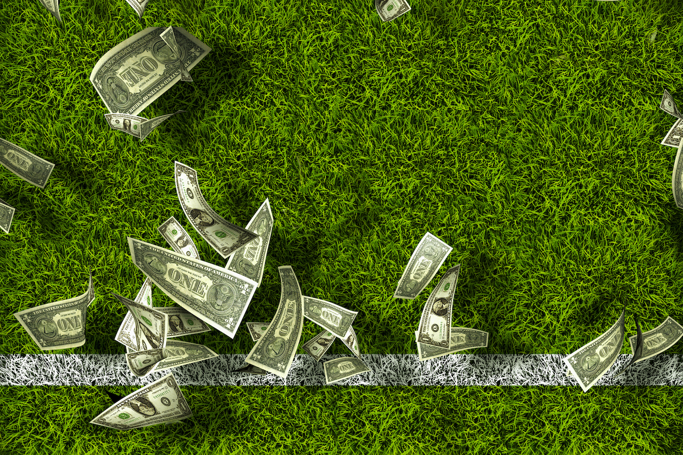 An illustration of U.S. dollar bills scattered across a green football field, crossing a white yard line.
