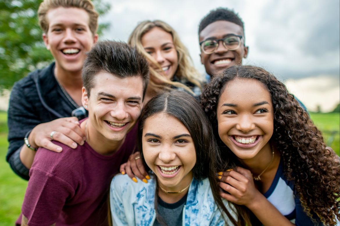 Six adolescents smiling for the camera