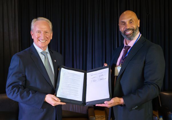 Gene Seroka, executive director of the Port of Los Angeles (left), and Darnell Hunt, UCLA’s interim chancellor hold the memorandum of understanding signed by the two institutions on Nov. 15, 2024