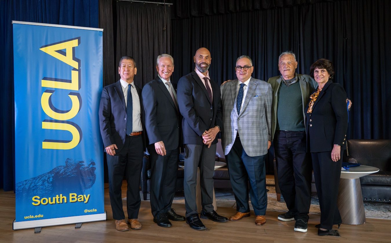 Group photo next to UCLA banner at South Bay Summit on Nov. 15, 2024