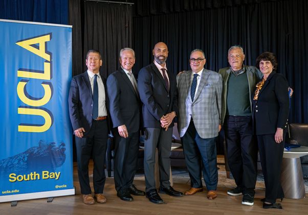 Group photo next to UCLA banner at South Bay Summit on Nov. 15, 2024