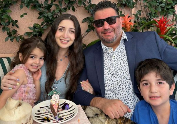 Four members of the Marfazelian family, including parents and two children, seated at table