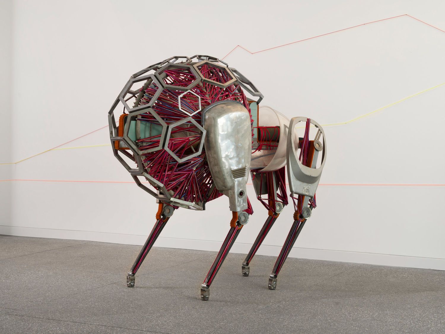 Red and silver sculpture with four "legs"