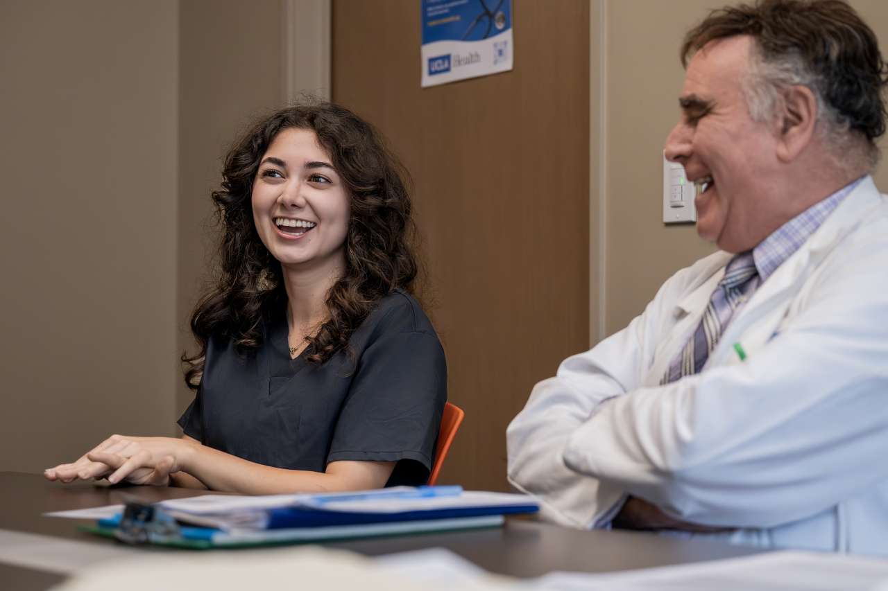 Nazeli Khodaverdyan, a fourth-year UCLA student who volunteers at the Familial Mediterranean Fever Clinic, with program co-director Dr. Wayne Grody.