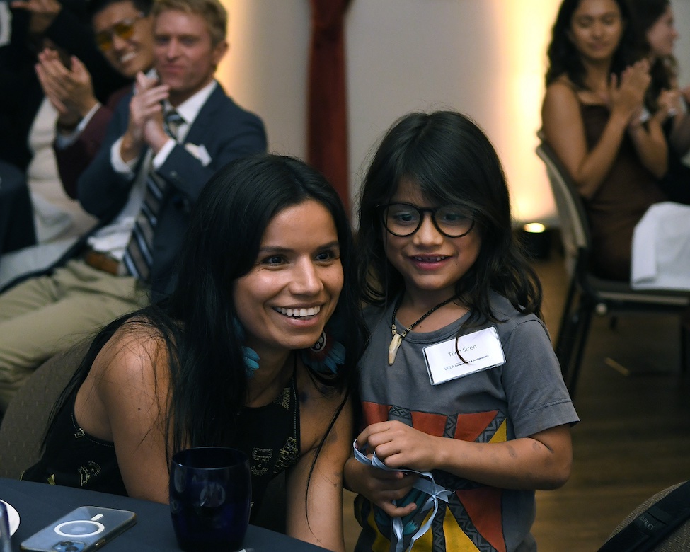 2024 Pritzker Emerging Environmental Genius Award winner Nina Gualinga poses next to a young child during a ceremony on the UCLA campus