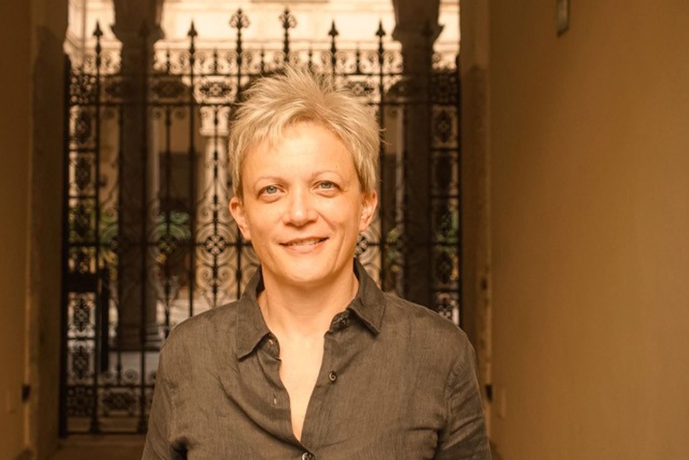 UCLA professor Zrinka Stahuljak stands in front of a metal gate