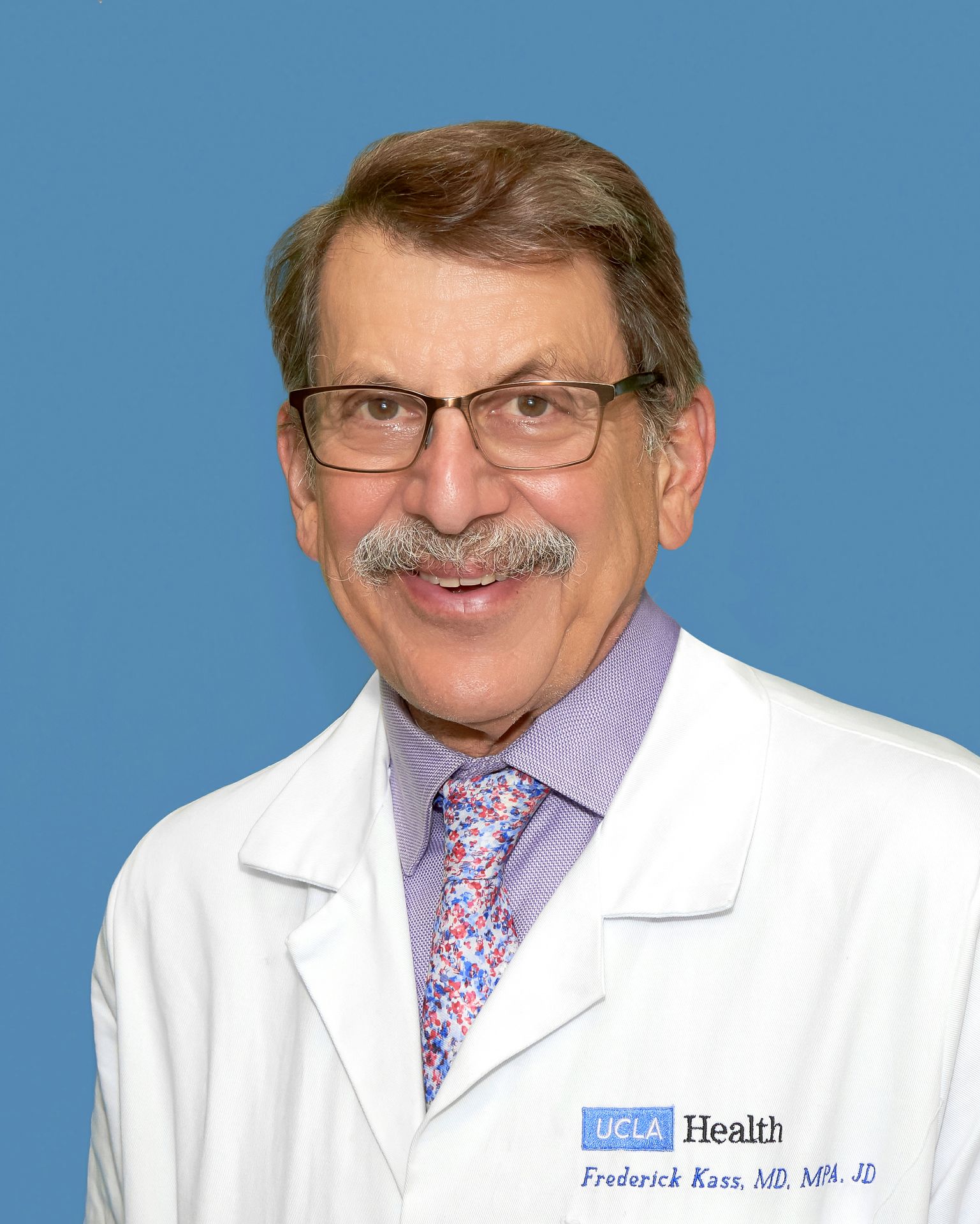 Portrait of Fred Kass in glasses, white coat and tie