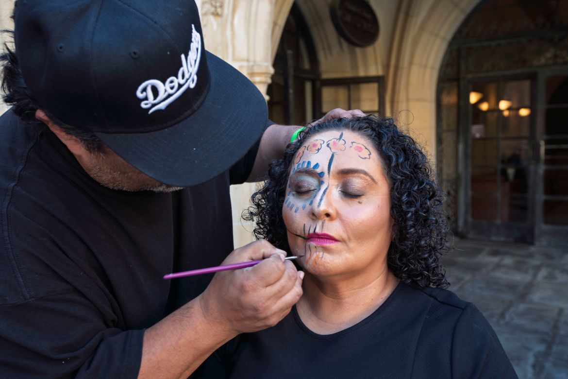 Chicano Studies Research Center assistant director Celia Lacayo gets her face painted in traditional Dia de los Muertos style.