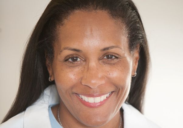 Head-and-shoulders image-of Karol Watson in white lab coat