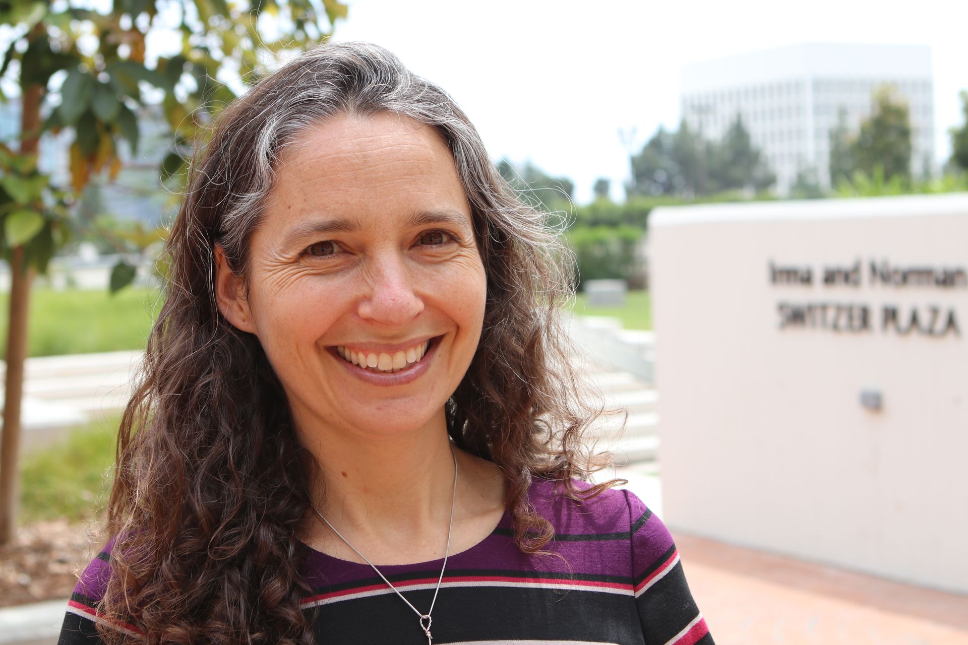 Portrait of Liz Barnert outdoors in striped shirt 