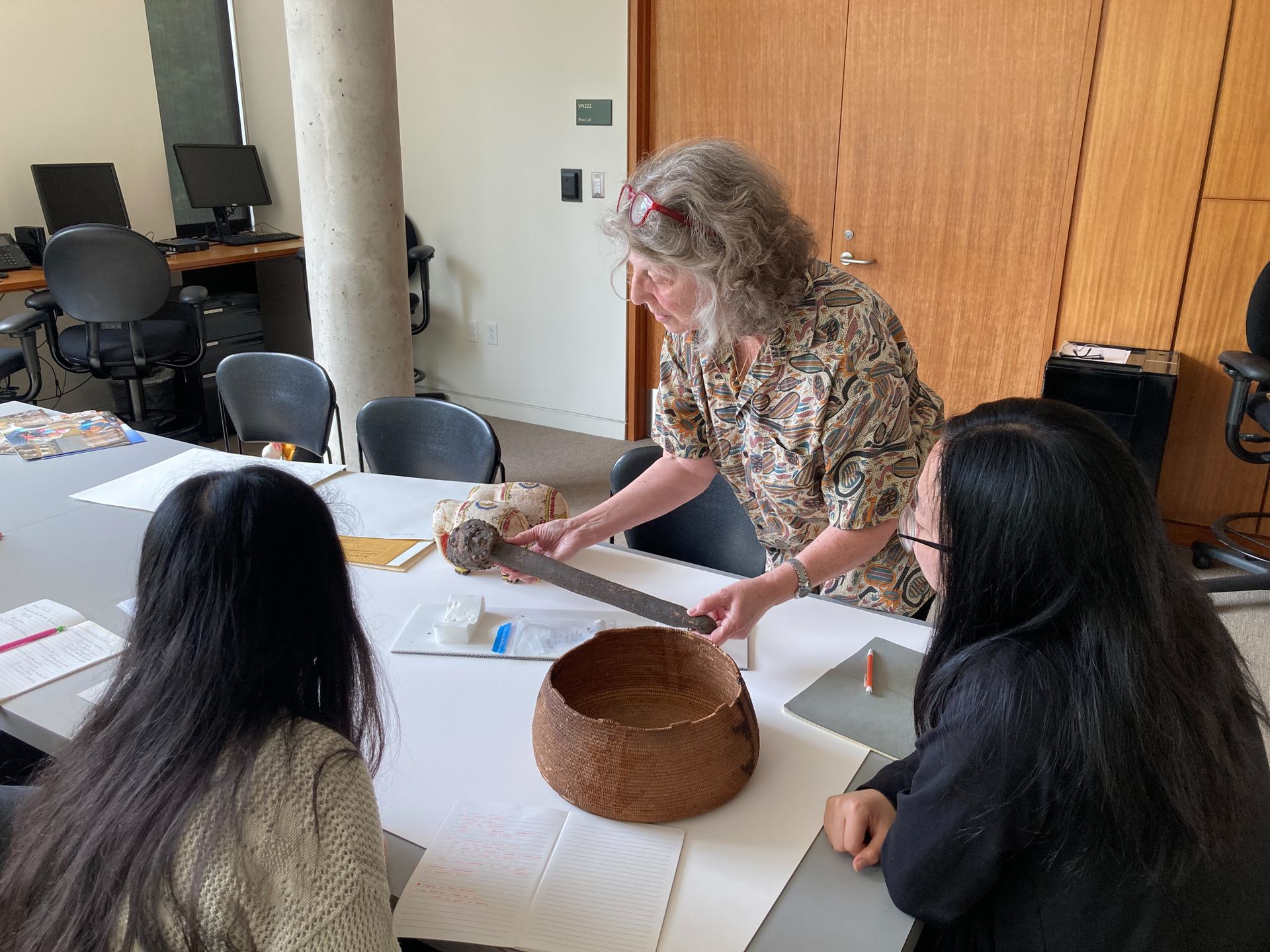 Ellen Pearlstein holding object while teaching