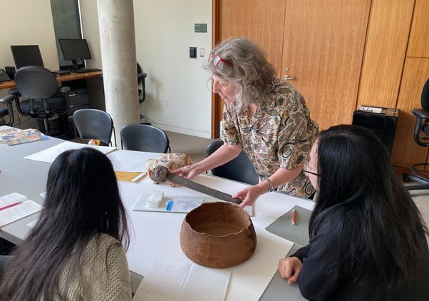 Ellen Pearlstein holding object while teaching