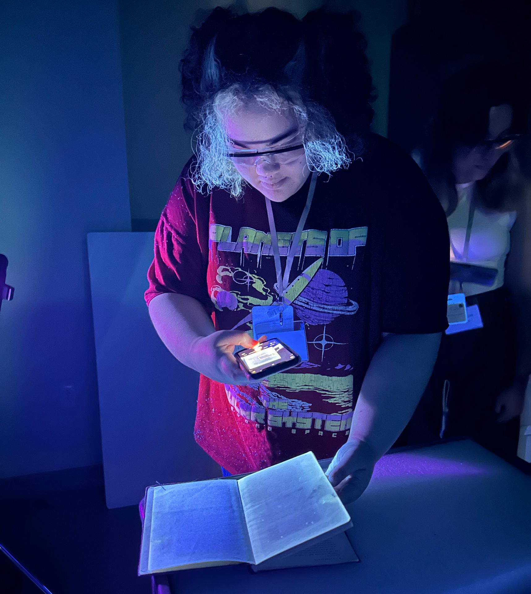 Dani Stanford holding a phone over a book