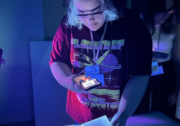 Dani Stanford holding a phone over a book
