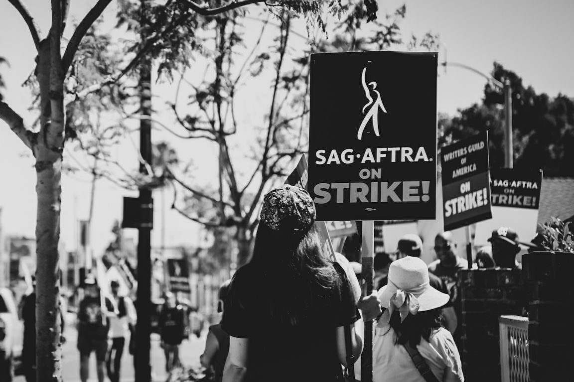 Black-and-white photo of striking Hollywood workers in Los Angeles
