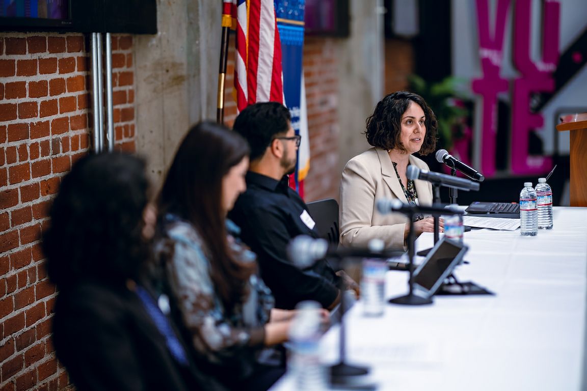 Silvia Gonzalez seated at table with three other panel members