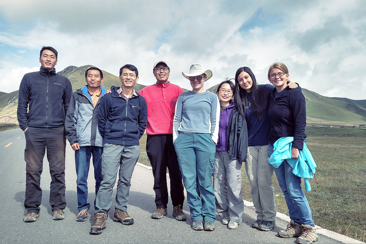 Group shot including Abijah Simon, second from right, and An Yin, center, wearing red
