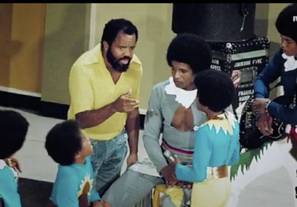 Video still of Berry Gordy with the Jackson 5