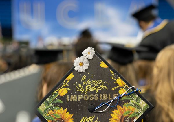 Mortarboard with the slogan “It always seems impossible until it’s done.”