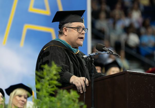 Sean Astin at podium in Pauley Pavilion