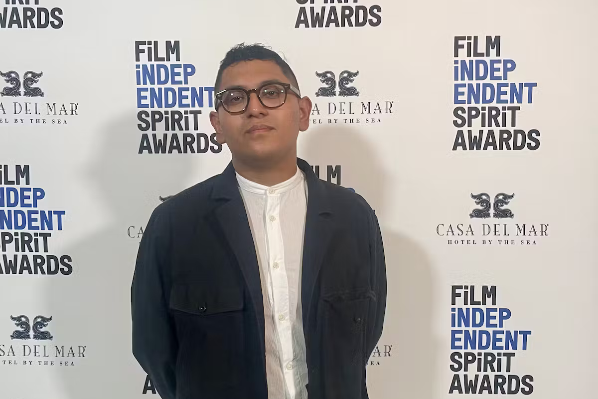 Pedro Murcia standing in front of wall with Film Independent Spirit Awards on it