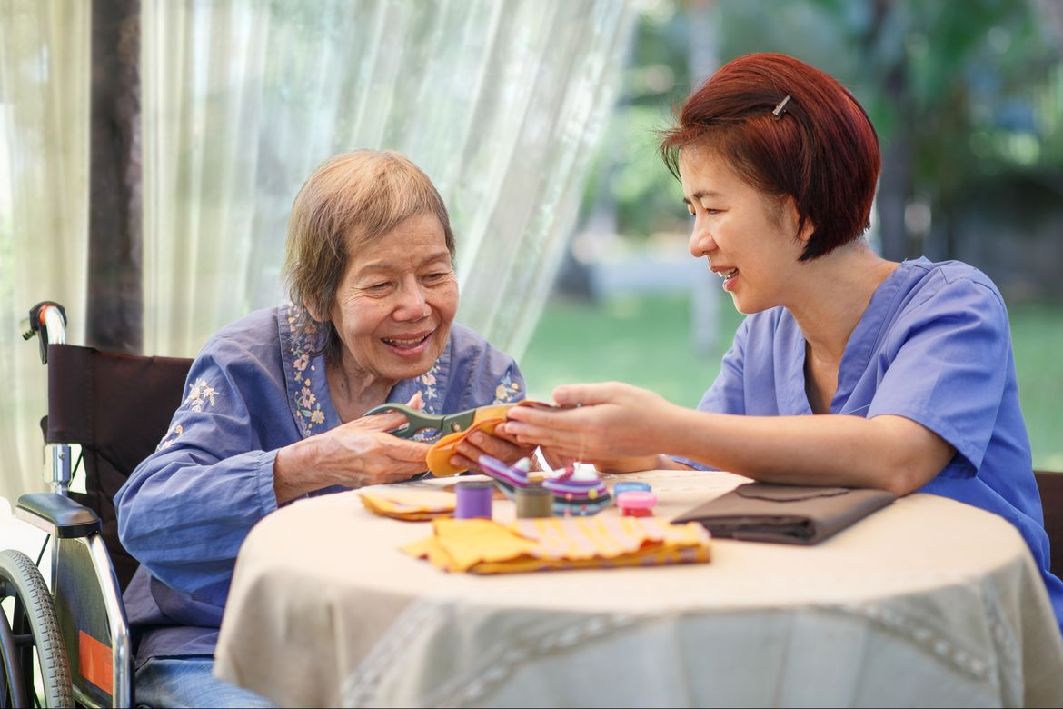 Older Asian woman with caregiver