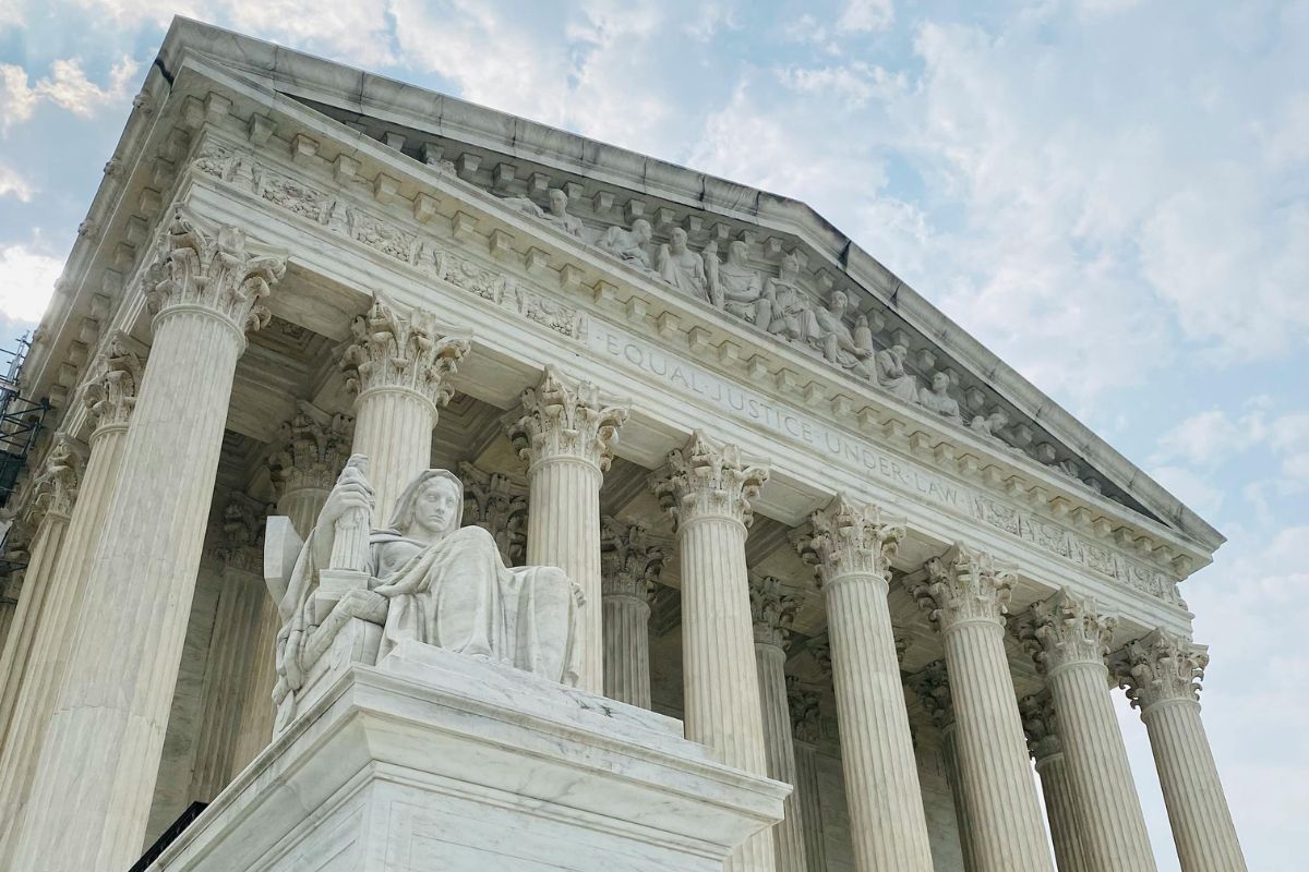 The exterior of the U.S. Supreme Court building, featuring its iconic white marble columns, classical sculptural frieze and the inscription "Equal Justice Under Law."