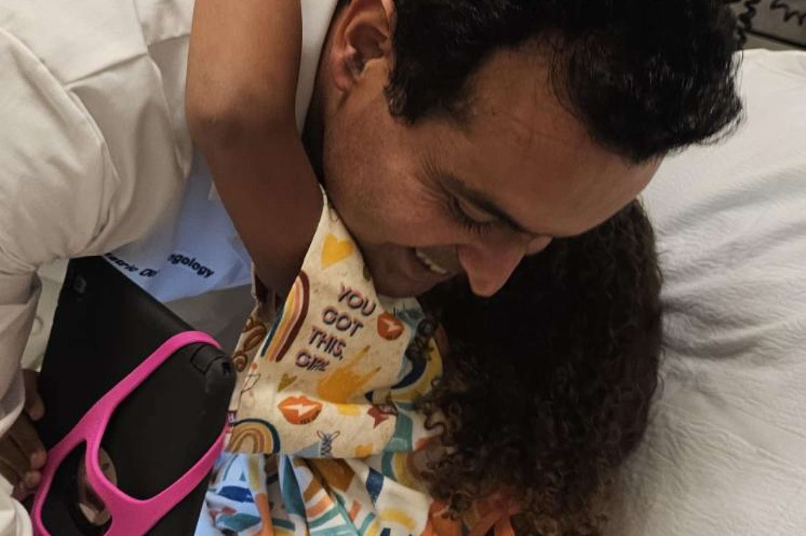 Sohit Kanotra hugs a patient