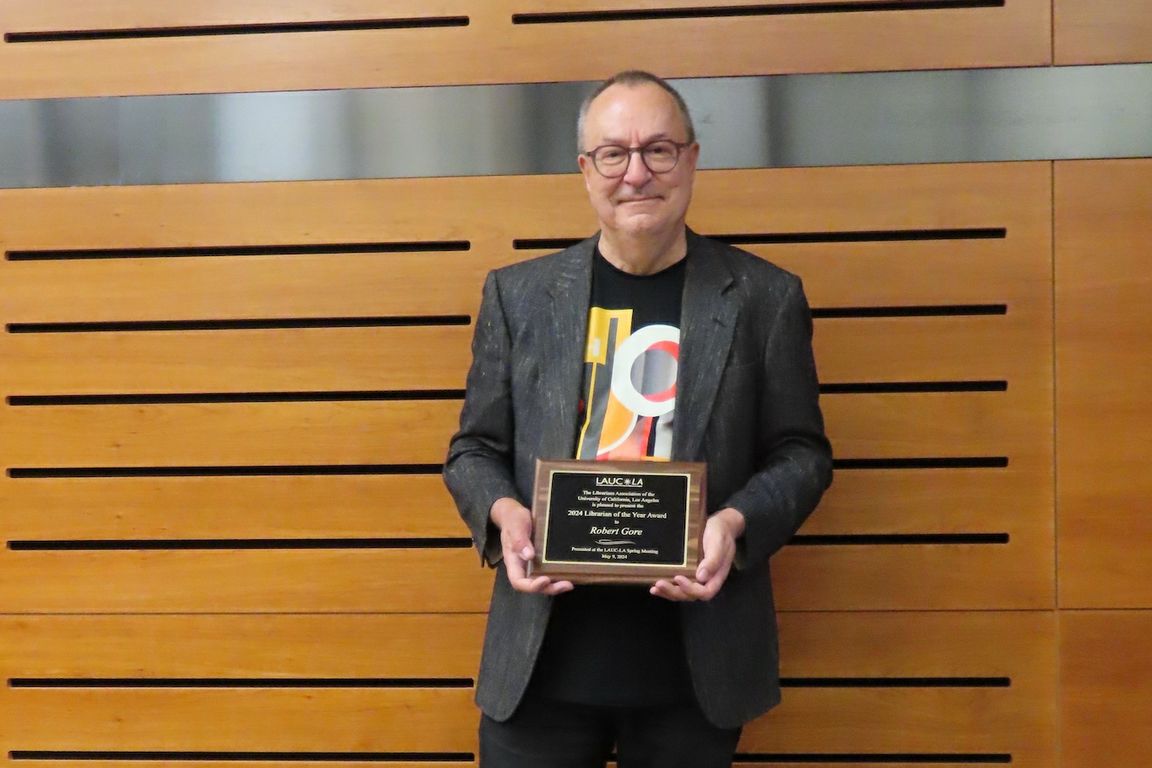Robert Gore–waist-up shot of Gore holding 2024 Librarian of the Year plaque