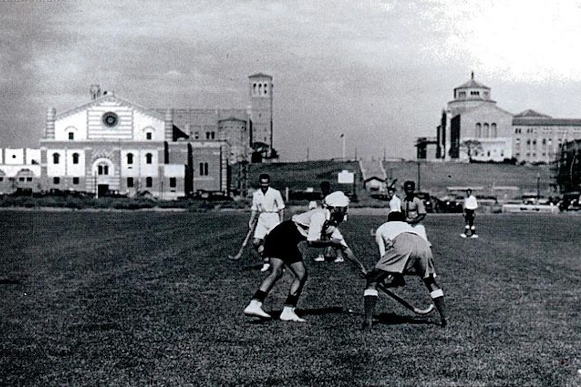Indian field hockey team training for 1932 Olympics on UCLA athletic field, with Royce Hall and Powell Library in the background