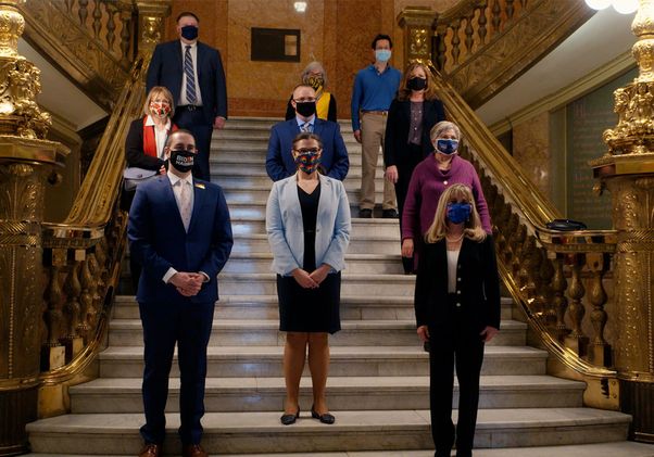 10 people standing on ornate staircase