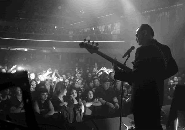 Black-and-white shot from behind of performer on stage