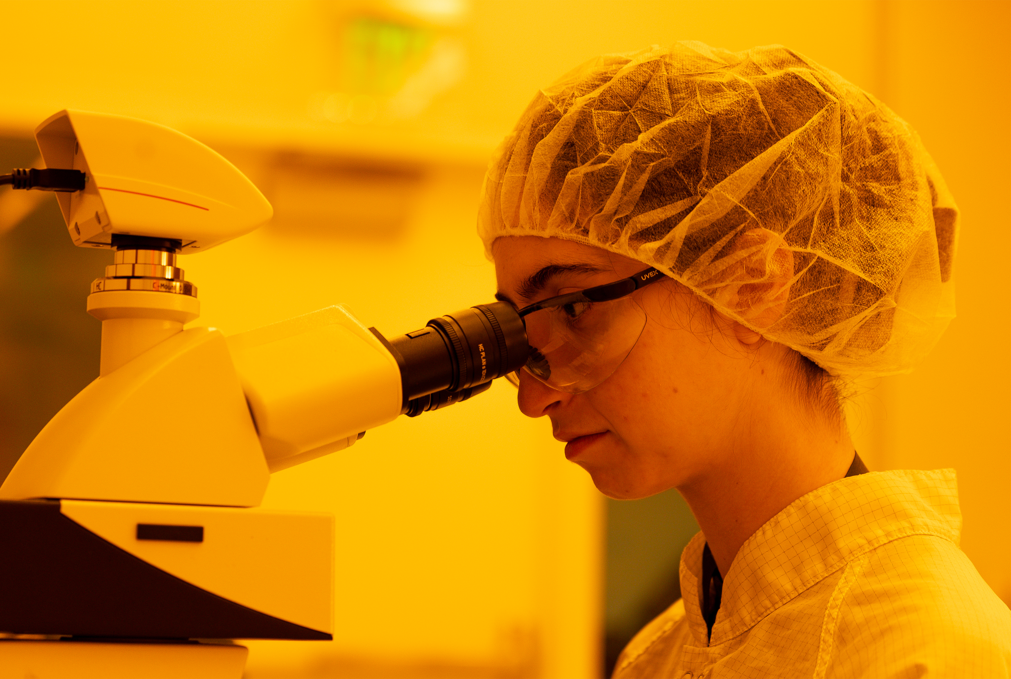Person in lab using microscope