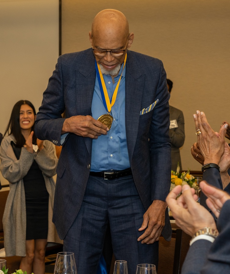 Abdul-Jabbar checks out the UC Presidential Medal during the ceremony.